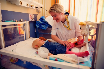 Verpleegster aan bed met kind